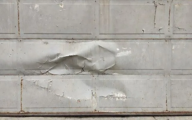 A dented and faded garage door panel